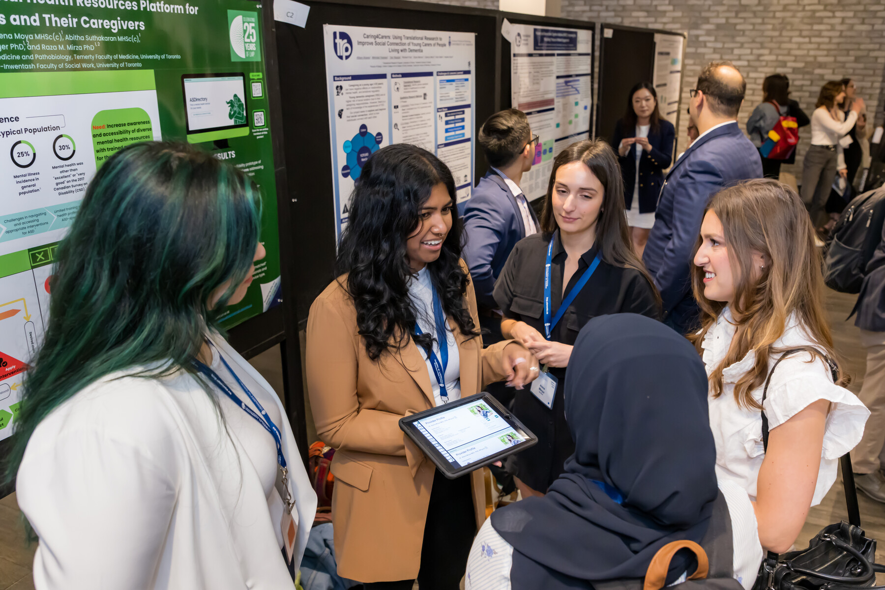 students discussing a poster at a conference